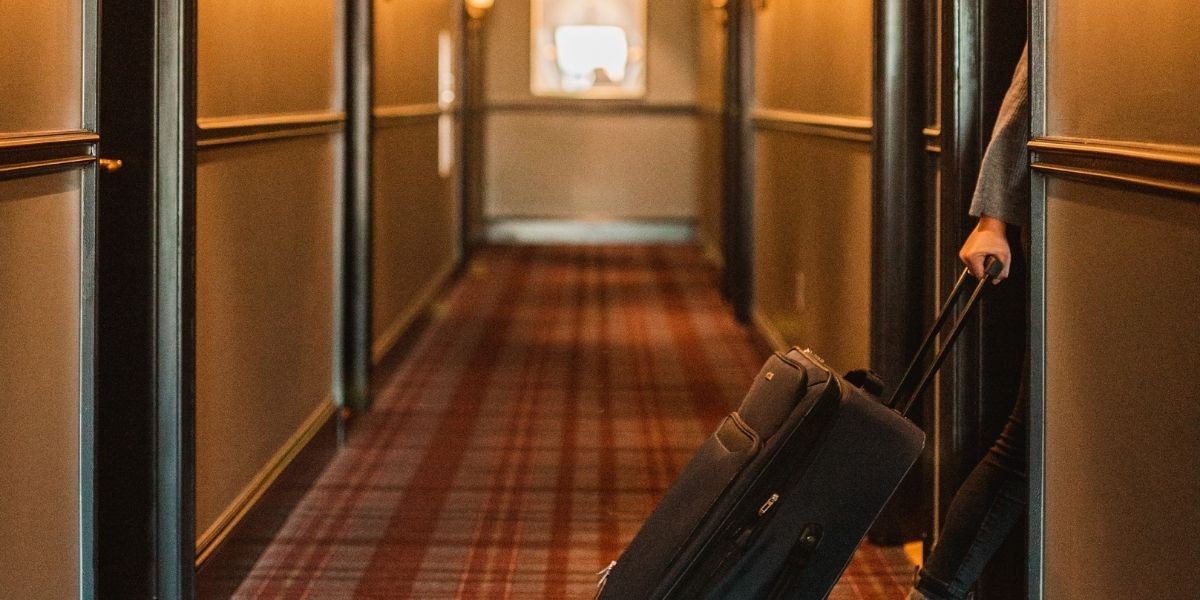 Hotel hallway with guest - proper hallway security and lighting protects guests